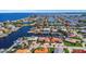 This aerial view of the community shows waterfront homes along winding canals leading to the sea at 5145 Porpoise Pl, New Port Richey, FL 34652