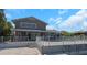 An expansive backyard featuring a covered patio, fenced pool and lovely landscaping on a sunny day at 5145 Porpoise Pl, New Port Richey, FL 34652
