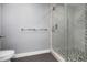 Modern bathroom featuring glass enclosed shower with decorative tile and a gray-tile floor at 5145 Porpoise Pl, New Port Richey, FL 34652