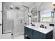 This primary bathroom showcases a double vanity, marble floors, and a glass shower at 5145 Porpoise Pl, New Port Richey, FL 34652