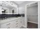 Elegant bathroom featuring double sinks, sleek vanity with modern fixtures, and decorative backsplash at 5145 Porpoise Pl, New Port Richey, FL 34652