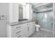 Modern bathroom vanity with stone counters, updated cabinets, and glass enclosed shower at 5145 Porpoise Pl, New Port Richey, FL 34652