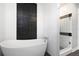 Bathroom featuring a modern soaking tub, mosaic tile, a shower with glass doors, and modern fixtures at 5145 Porpoise Pl, New Port Richey, FL 34652
