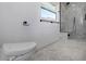 A bright bathroom featuring marble floors, a modern toilet, and sleek fixtures at 5145 Porpoise Pl, New Port Richey, FL 34652