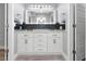 This bathroom showcases double sinks, sleek vanity, modern fixtures, and decorative backsplash at 5145 Porpoise Pl, New Port Richey, FL 34652