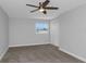 A modern primary bedroom featuring neutral walls, carpet, and a bright window at 5145 Porpoise Pl, New Port Richey, FL 34652