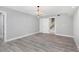 This bedroom features stylish wood flooring, a modern chandelier, and a double-door entry at 5145 Porpoise Pl, New Port Richey, FL 34652