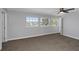 Bedroom featuring carpet, ceiling fan, and bright windows looking out to the canal at 5145 Porpoise Pl, New Port Richey, FL 34652