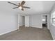 A modern primary bedroom featuring neutral walls, carpet, and a contemporary ceiling fan at 5145 Porpoise Pl, New Port Richey, FL 34652