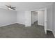 Spacious gray bedroom with carpet, ceiling fan, and closet at 5145 Porpoise Pl, New Port Richey, FL 34652