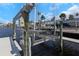 View of a private boat lift overlooking the waterway on a sunny day, providing convenient access to the water at 5145 Porpoise Pl, New Port Richey, FL 34652