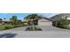 Charming home featuring a well-maintained lawn, beautiful flowers, and a paved driveway at 5145 Porpoise Pl, New Port Richey, FL 34652
