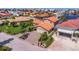 A front exterior view of a home with a well-manicured lawn, tile roof, and paver driveway at 5145 Porpoise Pl, New Port Richey, FL 34652