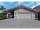 A close exterior view of garage and parking pad at 5145 Porpoise Pl, New Port Richey, FL 34652