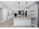 Modern kitchen boasts an island, stainless appliances, and sleek cabinetry in an open floor plan at 5145 Porpoise Pl, New Port Richey, FL 34652