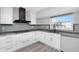 Well-lit kitchen featuring white cabinets, stainless steel appliances, and views of the canal at 5145 Porpoise Pl, New Port Richey, FL 34652