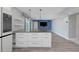 Beautiful kitchen island with stone counters, white cabinets, and pendant lights in an open layout at 5145 Porpoise Pl, New Port Richey, FL 34652
