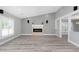 Bright living room with hardwood flooring, fireplace, and natural light at 5145 Porpoise Pl, New Port Richey, FL 34652