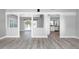 Spacious living room with hardwood floors and access to kitchen and lanai at 5145 Porpoise Pl, New Port Richey, FL 34652