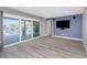 Bright living room with sliding glass doors to the patio, complete with a media center at 5145 Porpoise Pl, New Port Richey, FL 34652
