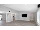 Open living room with neutral walls, modern floors, recessed lighting, and built-in speakers at 5145 Porpoise Pl, New Port Richey, FL 34652