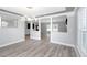 Bright living room with an open floor plan, modern light fixture, and a decorative support beam at 5145 Porpoise Pl, New Port Richey, FL 34652
