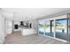 Open living area with kitchen, dining, and access to the outdoor patio area with water views at 5145 Porpoise Pl, New Port Richey, FL 34652