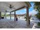 Entertain guests on the expansive patio overlooking the water, complete with ceiling fans and ample seating at 5145 Porpoise Pl, New Port Richey, FL 34652