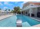 Beautiful backyard pool with water feature and lush landscaping offers a private oasis at 5145 Porpoise Pl, New Port Richey, FL 34652