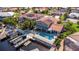A backyard featuring a covered patio, fenced pool, and private dock on the canal at 5145 Porpoise Pl, New Port Richey, FL 34652