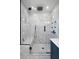 This glass enclosed marble shower features a rainfall shower head and a built-in bench at 5145 Porpoise Pl, New Port Richey, FL 34652