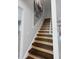 Modern staircase with wood steps and neutral wall color at 5145 Porpoise Pl, New Port Richey, FL 34652