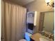 Small bathroom with a shower, toilet, vanity, and wall cabinet at 5391 Pillar Ave, Spring Hill, FL 34608