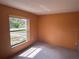 Bedroom with carpet flooring, and a large window with natural lighting at 5391 Pillar Ave, Spring Hill, FL 34608