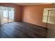Bedroom with laminate flooring, natural lighting, and a sliding glass door at 5391 Pillar Ave, Spring Hill, FL 34608