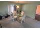Cozy dining room with a glass table, four chairs, and sliding glass doors at 5391 Pillar Ave, Spring Hill, FL 34608