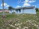 Exterior view of a single-story home, showcasing its unique architecture and surrounding yard at 5391 Pillar Ave, Spring Hill, FL 34608