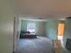 Spacious living room with carpet flooring and a light gray sofa by the window at 5391 Pillar Ave, Spring Hill, FL 34608