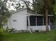 A quaint one-story home boasts a screened lanai and mature landscaping at 5625 Van Doren Ave, New Port Richey, FL 34652