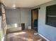 A sunroom featuring damaged floors, blue walls, and views to the outside at 5625 Van Doren Ave, New Port Richey, FL 34652