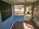 Sunroom featuring multiple windows and damaged flooring awaiting renovation at 5625 Van Doren Ave, New Port Richey, FL 34652