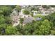 Aerial view of the house showing the roof, the property, surrounding trees, a pond, and other houses in the neighborhood at 5747 Fieldspring Ave, New Port Richey, FL 34655