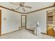 An empty bedroom features tile floors, a ceiling fan, and an open closet at 5747 Fieldspring Ave, New Port Richey, FL 34655