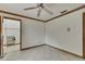 An empty bedroom has a ceiling fan, tiled floor, and mirrored closet at 5747 Fieldspring Ave, New Port Richey, FL 34655