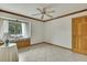 A clean and empty bedroom showcases a window seat and tiled floors at 5747 Fieldspring Ave, New Port Richey, FL 34655
