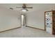 Bedroom featuring tile flooring, ceiling fan, and closet with mirrored doors at 5747 Fieldspring Ave, New Port Richey, FL 34655