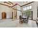 Spacious dining room with tile floors, wooden accents, and a view of lush greenery at 5747 Fieldspring Ave, New Port Richey, FL 34655