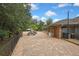 The brick home features a spacious brick-paved area with outdoor seating and lush landscaping creating a serene environment at 5747 Fieldspring Ave, New Port Richey, FL 34655