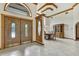 Bright foyer features tile flooring, wood trim and entry doors, chandelier, and dining room at 5747 Fieldspring Ave, New Port Richey, FL 34655