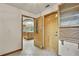 Hallway view of the spacious kitchen, showcasing wooden cabinetry and a bright, inviting atmosphere at 5747 Fieldspring Ave, New Port Richey, FL 34655